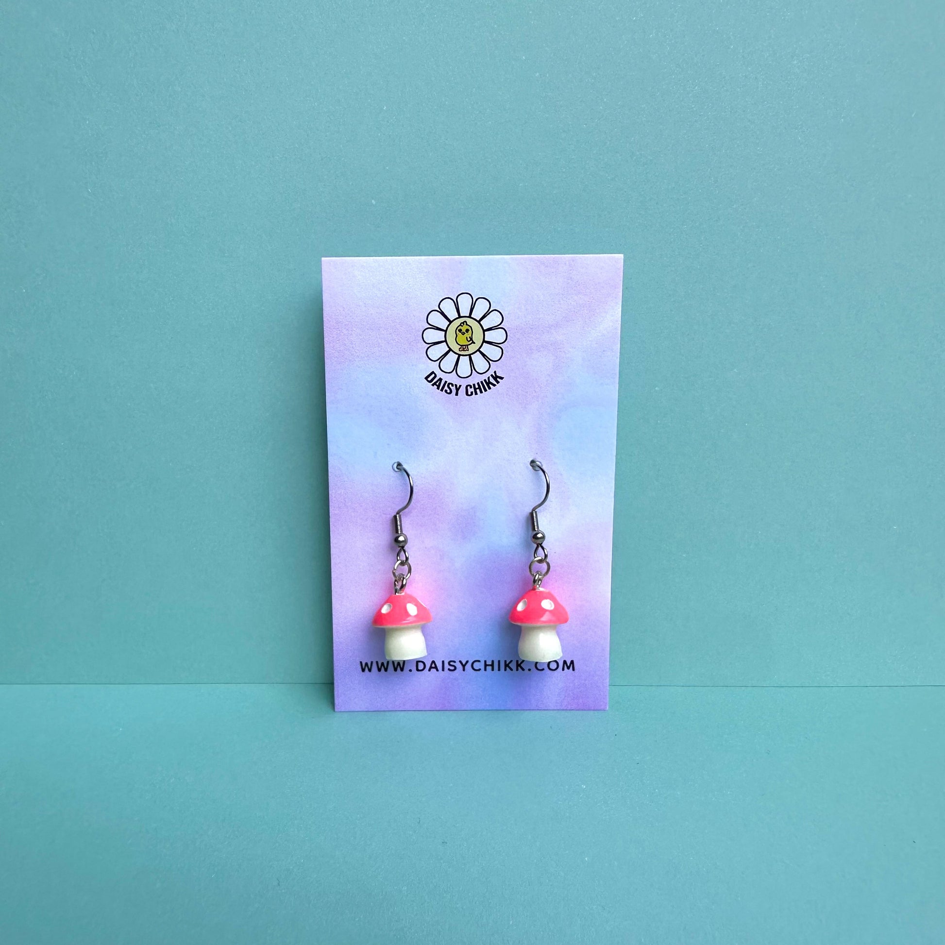 Pink mushroom earrings on pastel Daisy Chikk backing card – kawaii toadstool jewellery for cottagecore aesthetic
