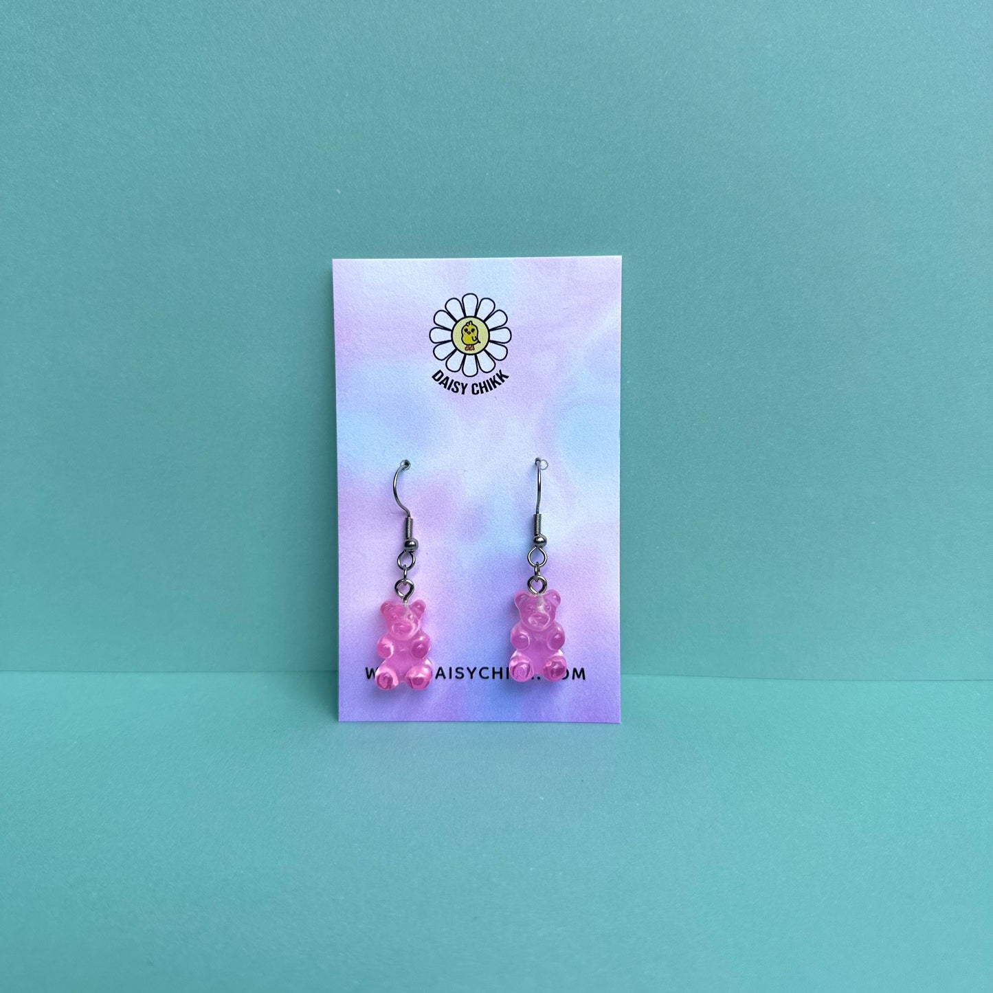 Pink gummy bear earrings on silver hooks displayed on a pastel Daisy Chikk backing card – handmade kawaii resin earrings