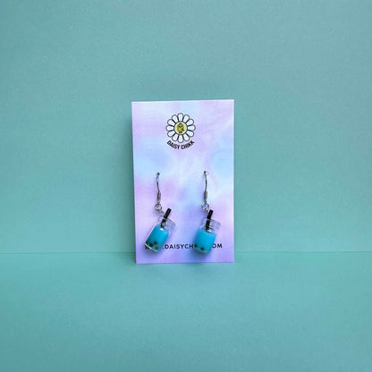 Blue boba tea earrings with silver hooks displayed on a pastel Daisy Chikk backing card – handmade kawaii bubble tea jewellery