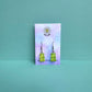 green gummy bear earrings on silver hooks displayed on a pastel Daisy Chikk backing card – handmade kawaii resin earrings
