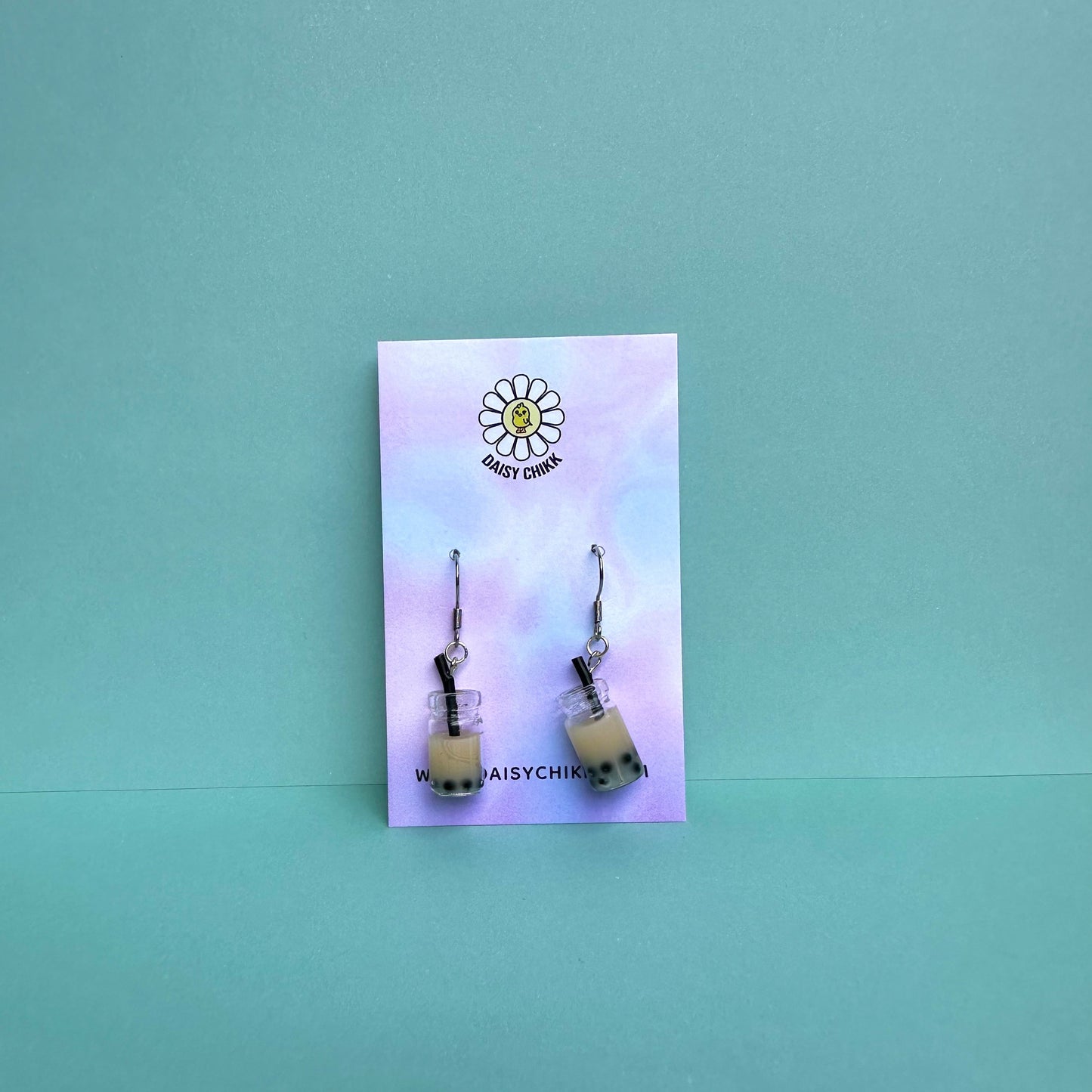 milk boba tea earrings with silver hooks displayed on a pastel Daisy Chikk backing card – handmade kawaii bubble tea jewellery