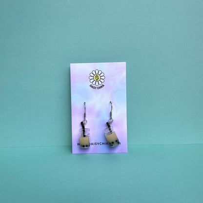 milk boba tea earrings with silver hooks displayed on a pastel Daisy Chikk backing card – handmade kawaii bubble tea jewellery