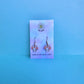 My melody earrings on Daisy Chikk pastel earring card with purple and blue ombré background – handmade Sanrio-style kawaii jewellery