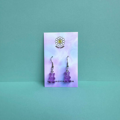 Purple gummy bear earrings on silver hooks displayed on a pastel Daisy Chikk backing card – handmade kawaii resin earrings