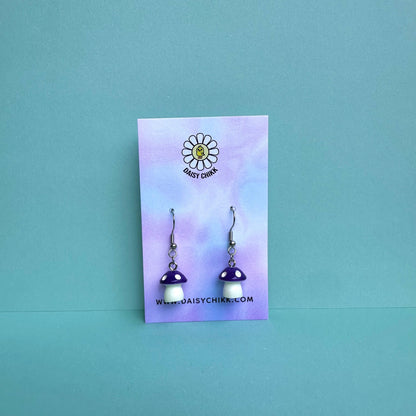 Purple mushroom earrings on pastel Daisy Chikk backing card – kawaii toadstool jewellery for cottagecore aesthetic