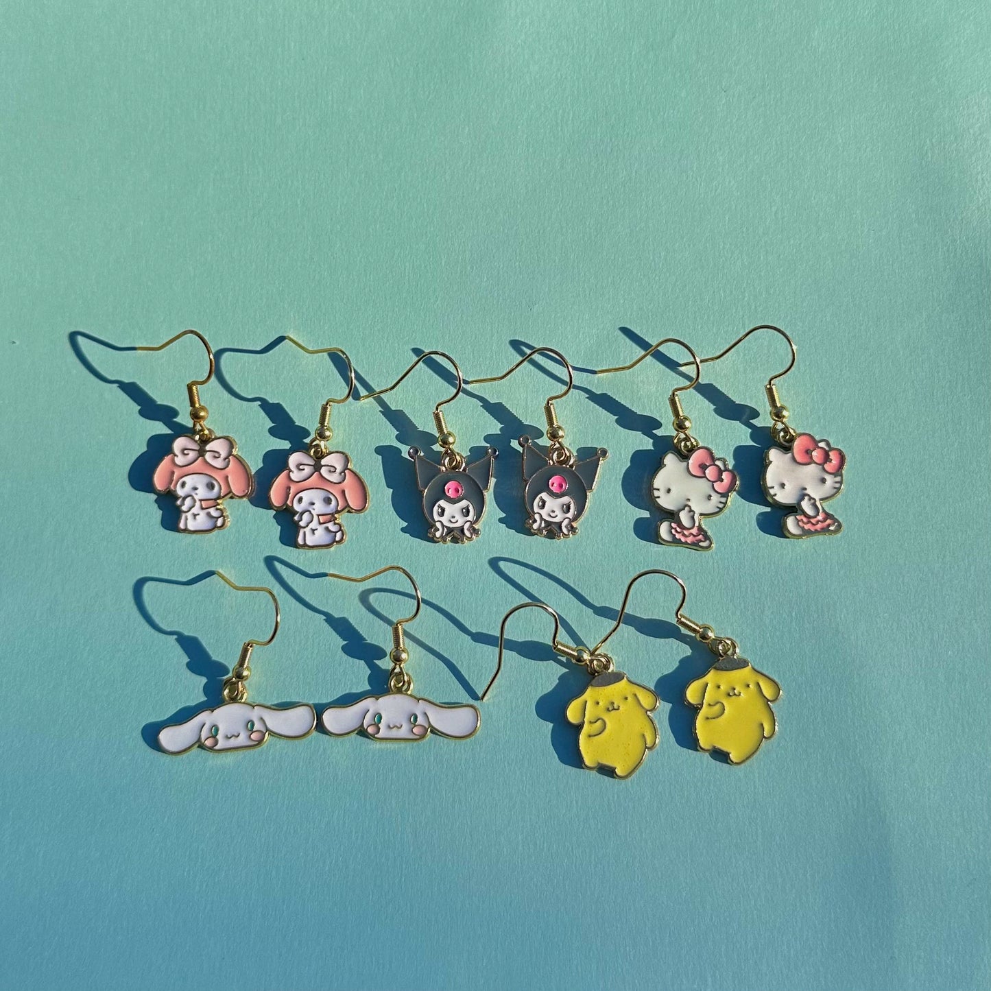 Kawaii Sanrio earrings collection including My Melody, Kuromi, Hello Kitty, Cinnamoroll, and Pompompurin – pastel charm earrings by Daisy Chikk