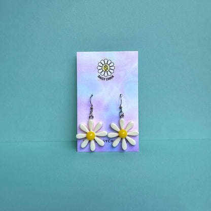 white daisy flower earrings with white centre on silver hooks, displayed on pastel Daisy Chikk backing card – kawaii handmade statement jewellery