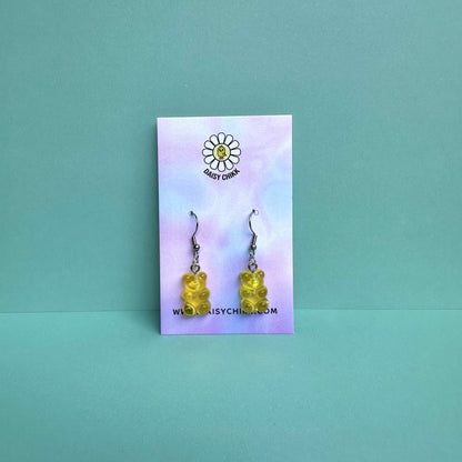 yellow gummy bear earrings on silver hooks displayed on a pastel Daisy Chikk backing card – handmade kawaii resin earrings