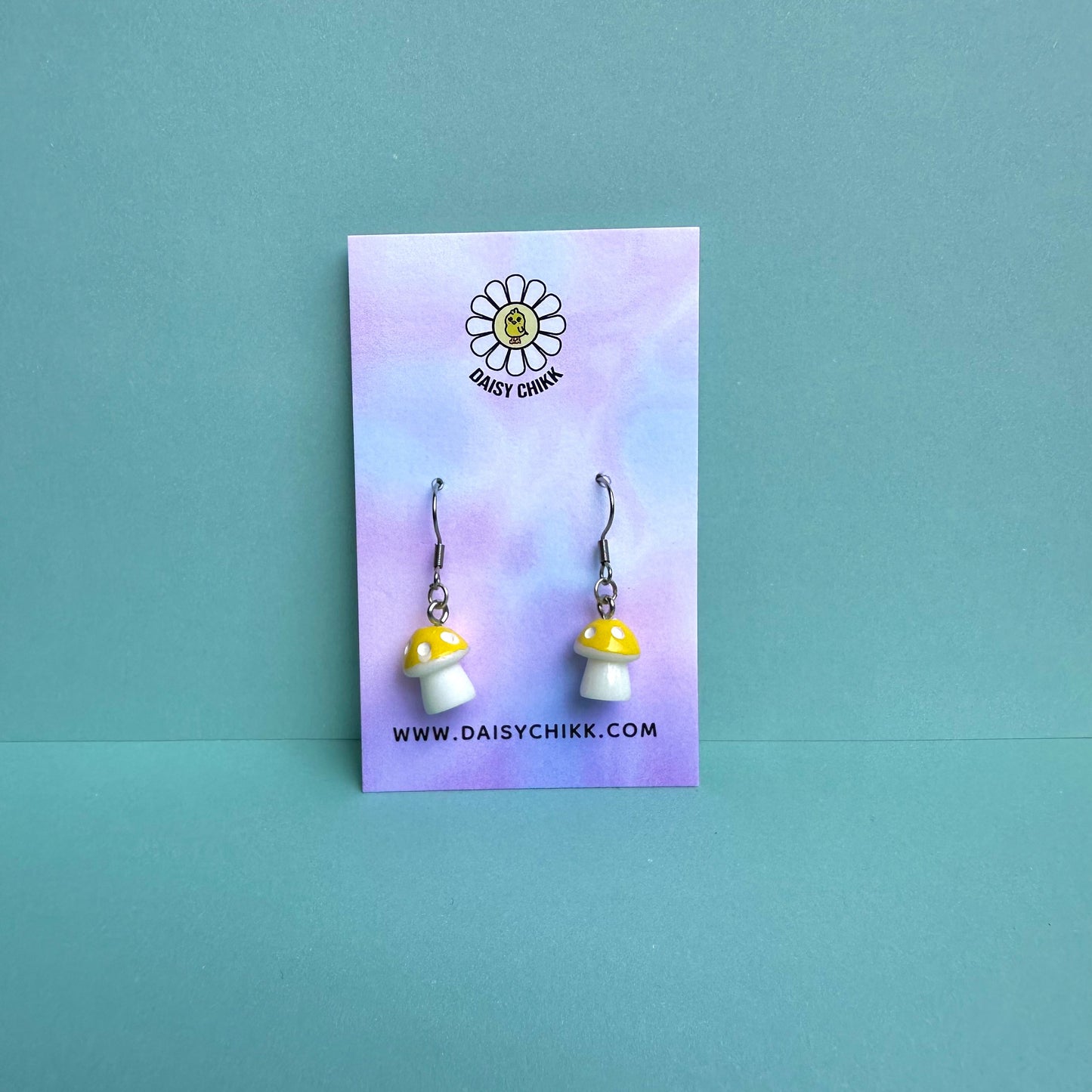 Yellow mushroom earrings on pastel Daisy Chikk backing card – kawaii toadstool jewellery for cottagecore aesthetic