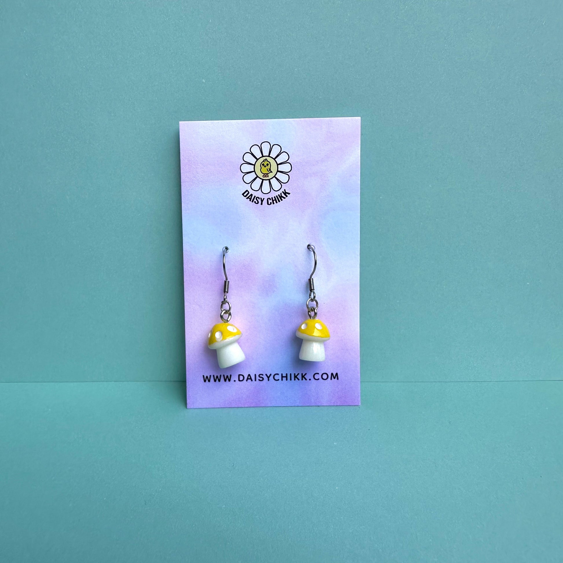 Yellow mushroom earrings on pastel Daisy Chikk backing card – kawaii toadstool jewellery for cottagecore aesthetic
