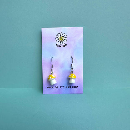 Yellow mushroom earrings on pastel Daisy Chikk backing card – kawaii toadstool jewellery for cottagecore aesthetic