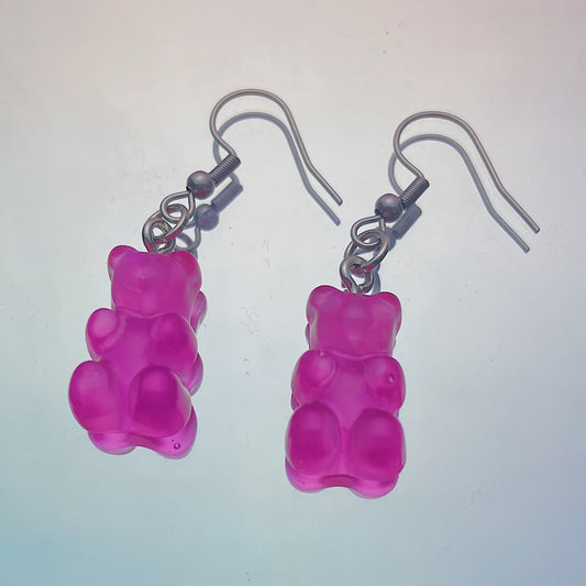 Close-up of translucent hot pink gummy bear earrings with silver hooks on a pastel background – kawaii Y2K handmade jewellery